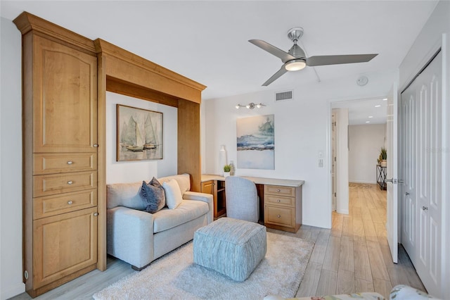 sitting room with light hardwood / wood-style floors and ceiling fan