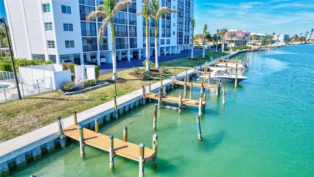 dock area with a water view and a lawn