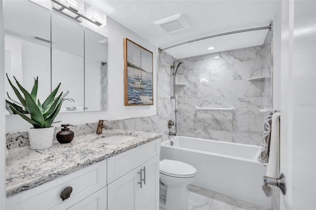 full bathroom with vanity, toilet, and tiled shower / bath combo