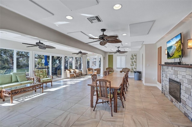 dining room featuring a fireplace and a wealth of natural light