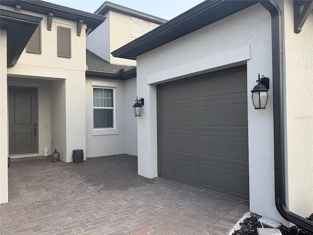 garage with decorative driveway