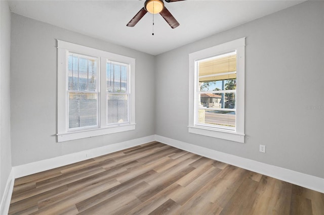 unfurnished room with hardwood / wood-style floors and ceiling fan