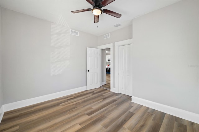 spare room with ceiling fan and hardwood / wood-style floors