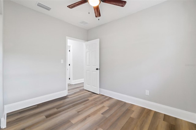 spare room featuring wood-type flooring and ceiling fan