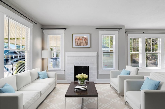 living room with a brick fireplace and plenty of natural light