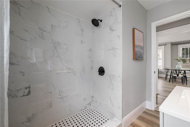 1010 E Lake Ave, Tampa, FL 33605 - full bathroom featuring tiled shower, baseboards, wood finished floors, and vanity