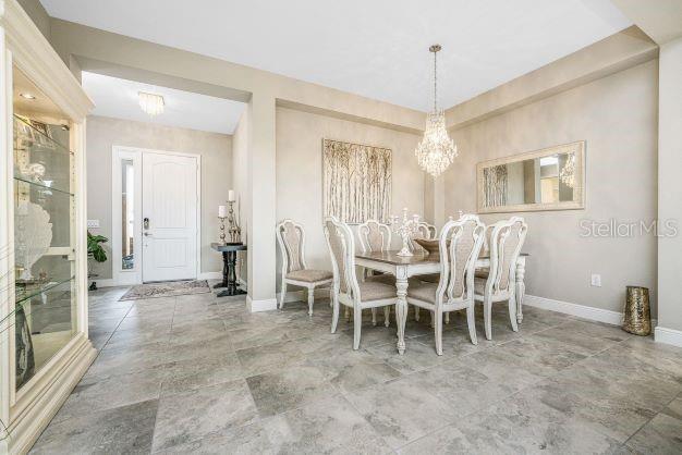 dining area with an inviting chandelier