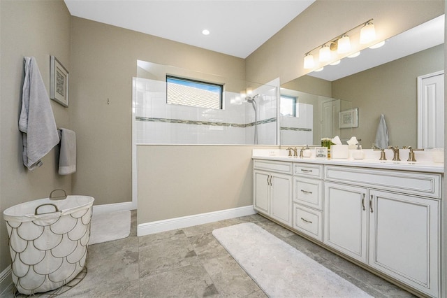 bathroom with vanity and a tile shower