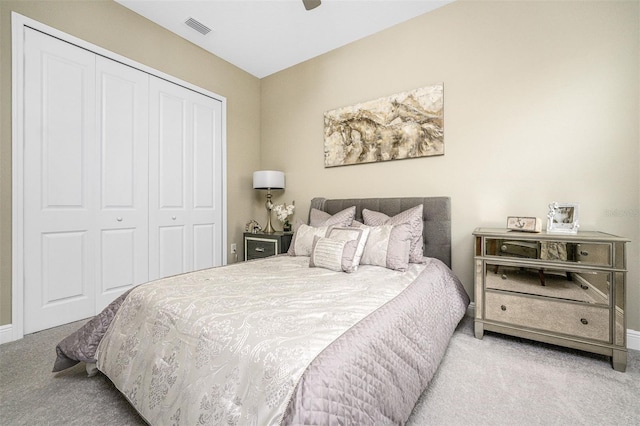 carpeted bedroom featuring ceiling fan and a closet