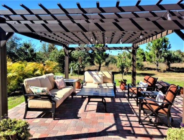 view of patio featuring an outdoor hangout area and a pergola