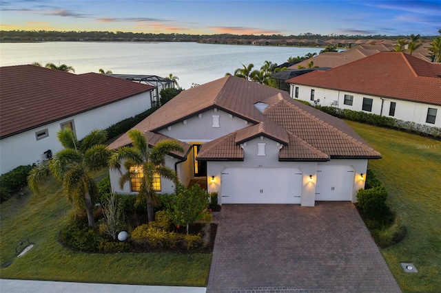 aerial view at dusk with a water view