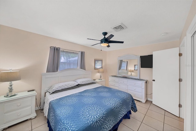 tiled bedroom featuring ceiling fan