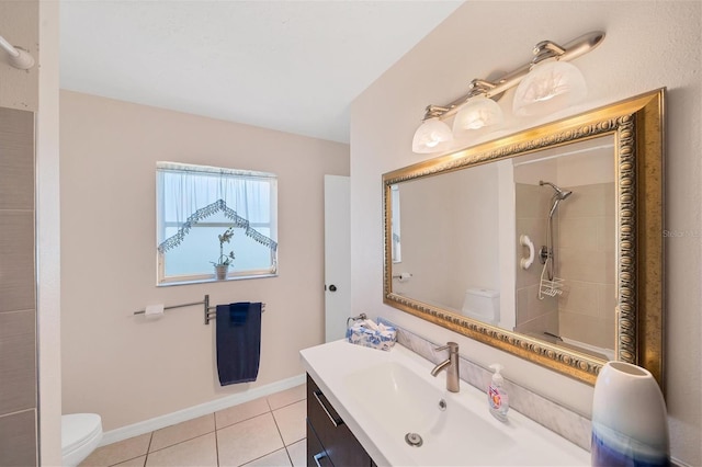 bathroom featuring tile patterned floors, toilet, vanity, and a shower