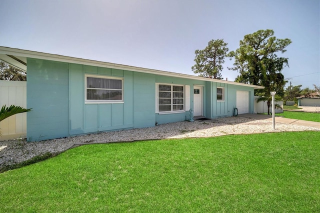 ranch-style home featuring a garage and a front yard