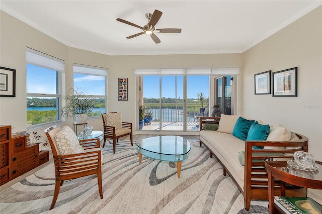 living room featuring a water view, ceiling fan, and ornamental molding