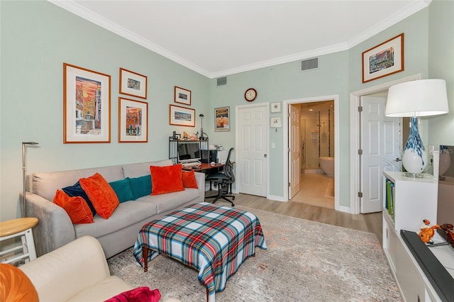 living room featuring crown molding and light wood-type flooring