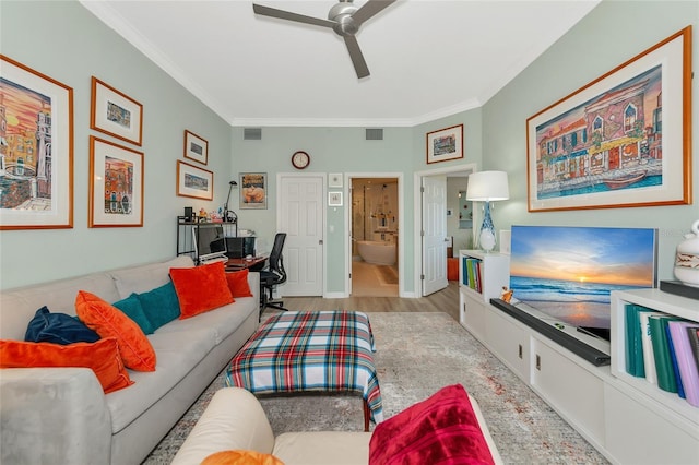 living room with ceiling fan, ornamental molding, and light hardwood / wood-style flooring