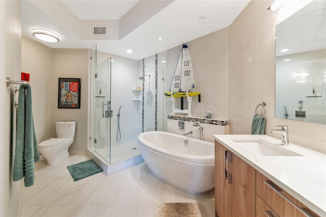 full bathroom featuring vanity, toilet, and separate shower and tub