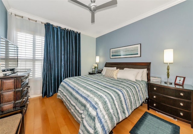 bedroom featuring ornamental molding, ceiling fan, and light hardwood / wood-style floors