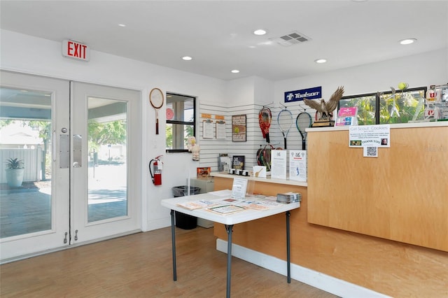 office area featuring a wealth of natural light, light hardwood / wood-style floors, and french doors