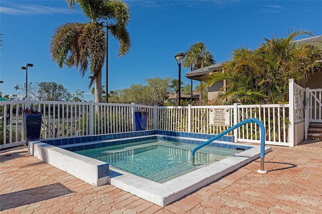 view of swimming pool with a community hot tub