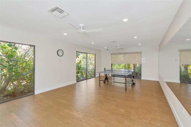 recreation room featuring light hardwood / wood-style flooring and ceiling fan