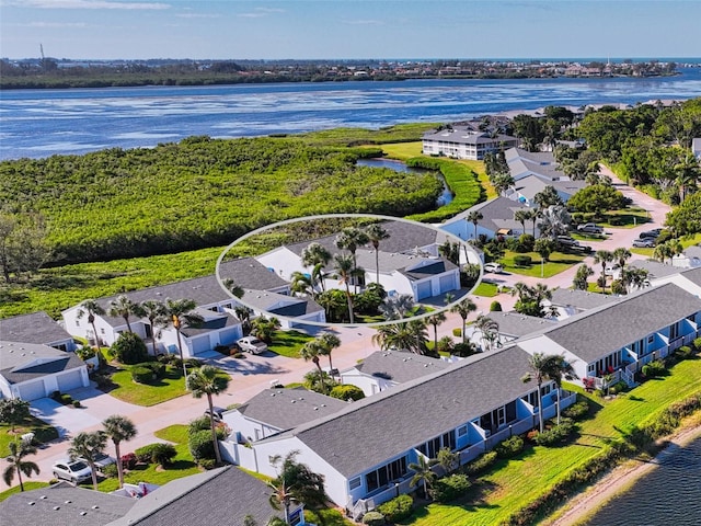 birds eye view of property with a water view