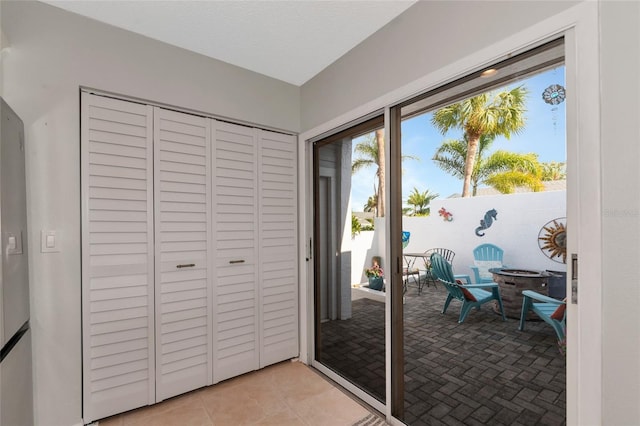 doorway with light tile patterned floors