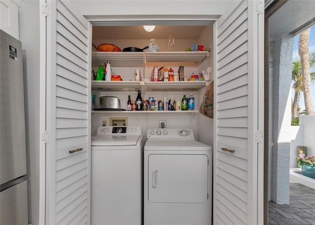 washroom featuring washing machine and dryer