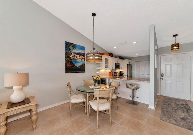 dining room featuring vaulted ceiling