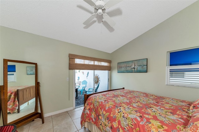 tiled bedroom featuring ceiling fan and lofted ceiling