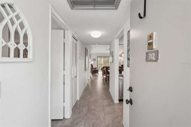 corridor with a textured ceiling