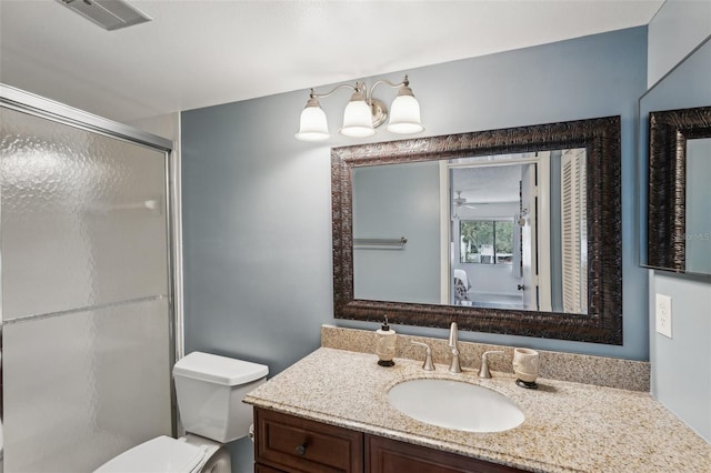 bathroom with vanity, toilet, and walk in shower