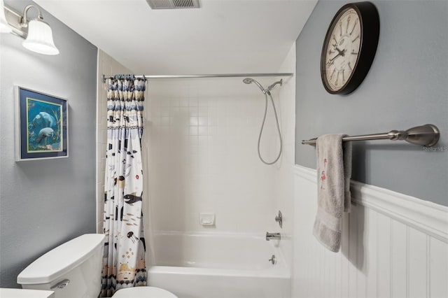 bathroom with shower / tub combo with curtain and toilet