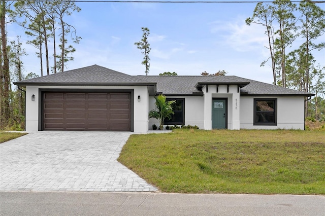 view of front of property featuring a garage and a front lawn