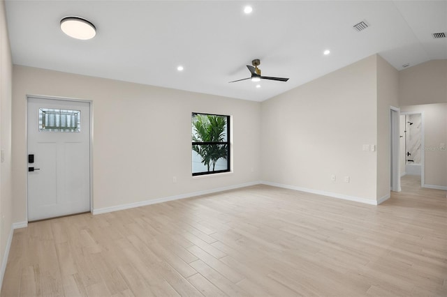 spare room with ceiling fan, lofted ceiling, and light hardwood / wood-style floors