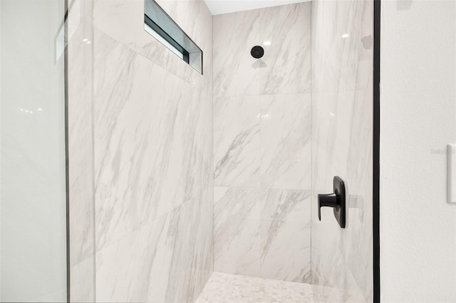 interior details with a tile shower