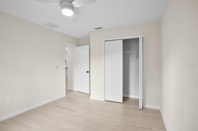 unfurnished bedroom with light hardwood / wood-style flooring, a closet, and ceiling fan