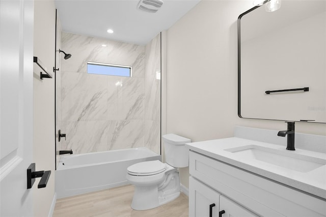 full bathroom featuring vanity, wood-type flooring, toilet, and tiled shower / bath