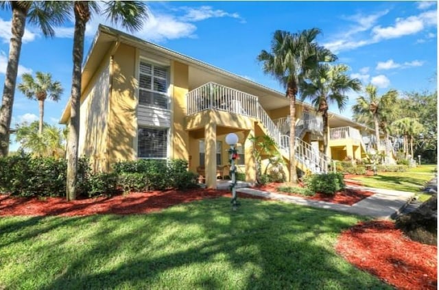 mediterranean / spanish home with a front yard