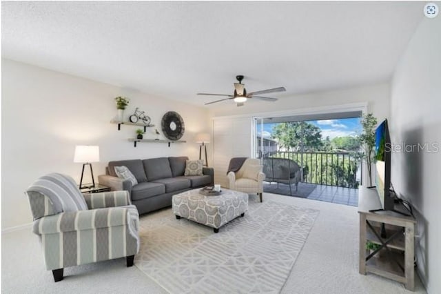 living room with light carpet and a ceiling fan