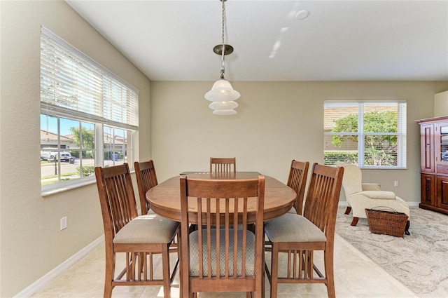 dining room featuring a healthy amount of sunlight and light tile patterned floors