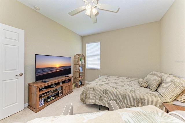 bedroom featuring light colored carpet and ceiling fan