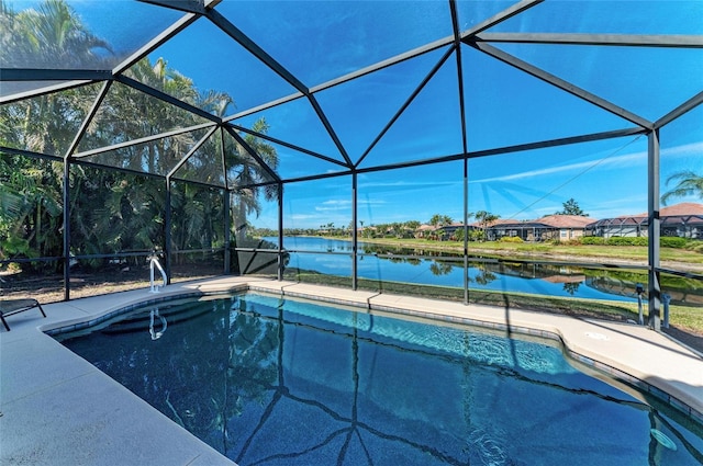 view of pool with a water view, glass enclosure, and a patio area