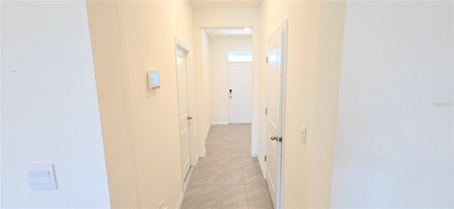 corridor with light tile patterned flooring