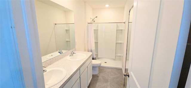 bathroom featuring vanity, toilet, and a shower