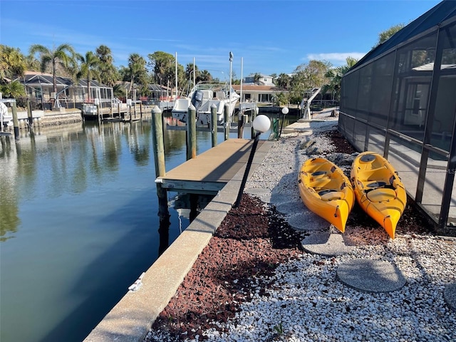 dock area featuring a water view and glass enclosure