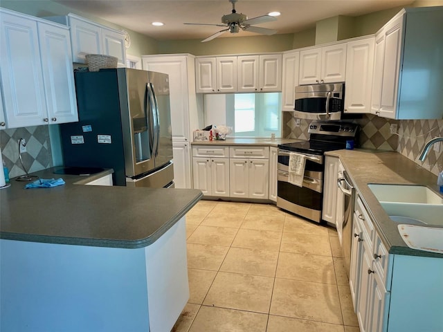 kitchen with appliances with stainless steel finishes and white cabinets