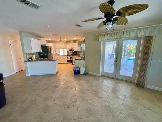 kitchen with stainless steel appliances, white cabinetry, backsplash, and french doors