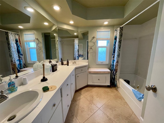 bathroom with a raised ceiling, vanity, shower / tub combo, and tile patterned floors